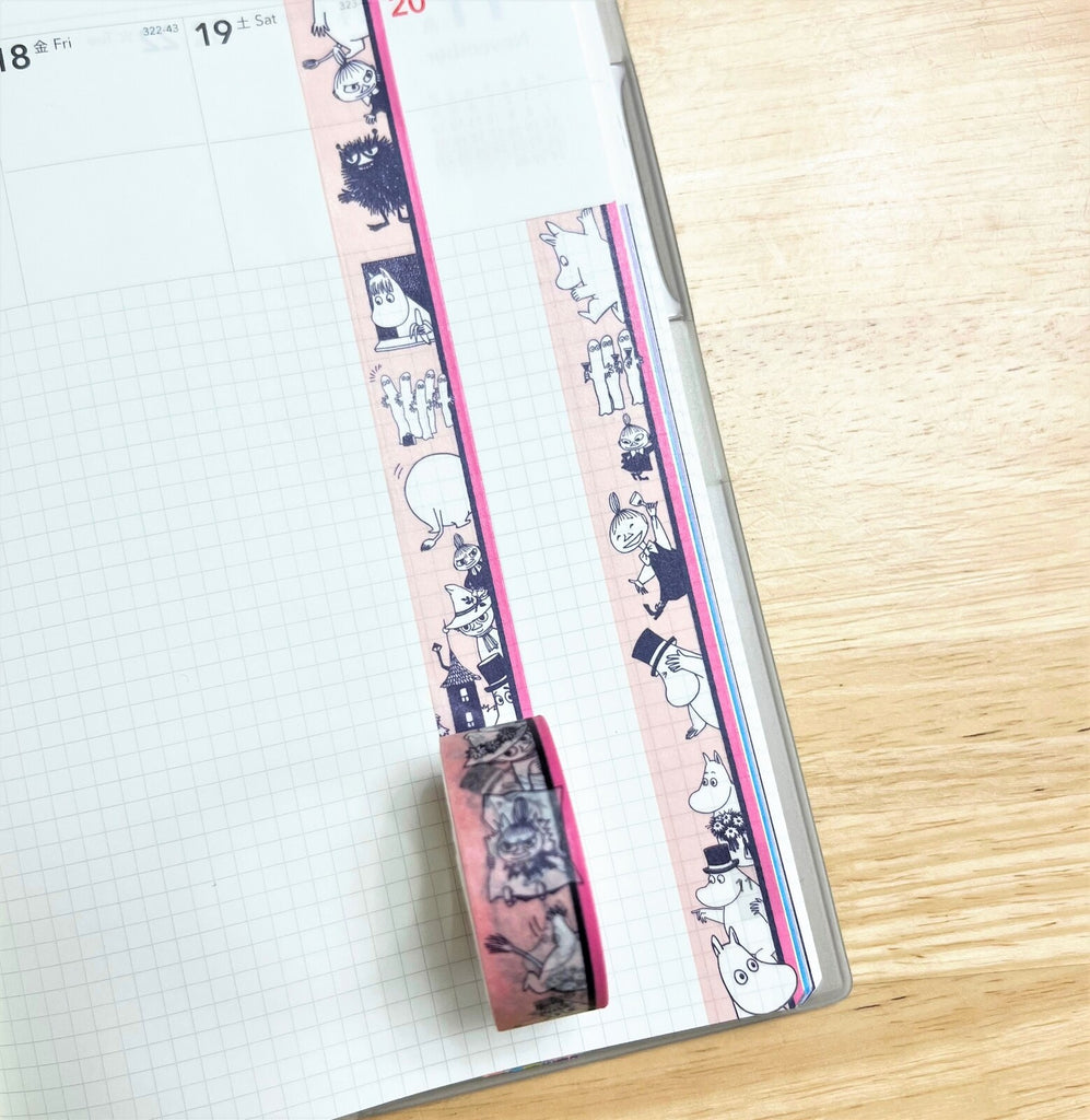 Moomin Striped Pink Masking Tape applied along the edge of a notebook page, adding a lively touch to the layout.
