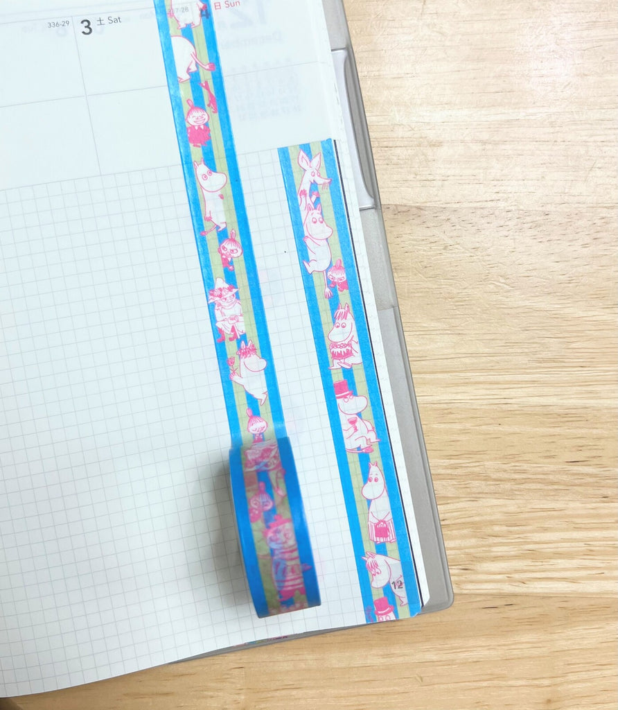 Moomin Striped Blue Masking Tape applied along a notebook page edge, adding a touch of colour and charm.
