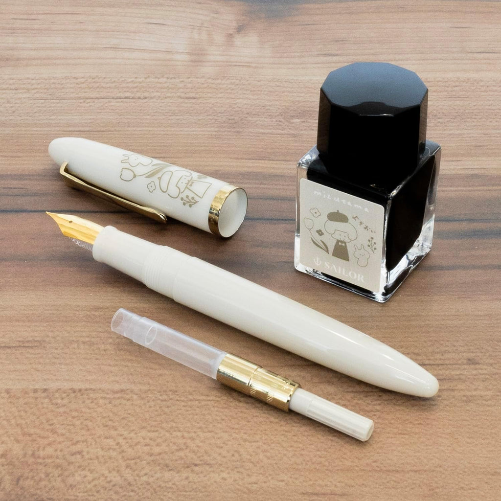 Sailor fountain pen set with ink, pen, and converter on a wooden surface.
